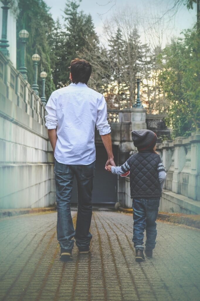 Father and son walking hand in hand.